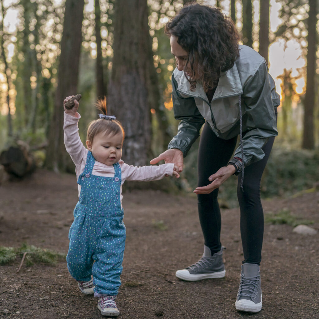 Proud one year old toddler taking her first steps